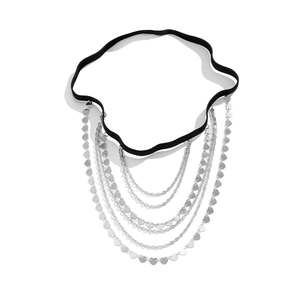 Detail of multi-layer silver leg chain with heart sequins and black elastic band