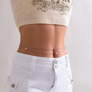 Detail of silver double-layered body chain featuring small heart pendants on a female model