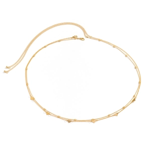 Detail of double-layer gold body chain featuring heart pendants and bead accents