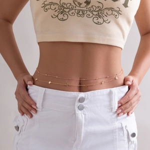 Detail of a gold double-layered waist chain featuring textured five-pointed star charms