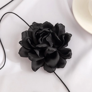 Close-up of a handmade black fabric rose choker with delicate layered silk petals