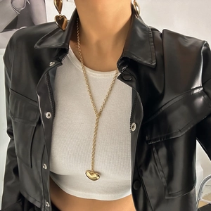 Minimalist gold heart chain necklace and matching earrings set worn by model
