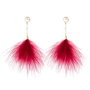 Detail of red feather tassel earrings with imitation pearls and gold chain links