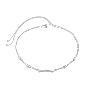 Detail view of double-layer silver metal waist chain featuring star charms and lobster clasp