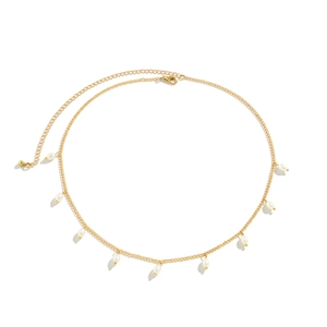 Detailed close-up of a gold chain leg jewelry featuring elegant drop pearls and lobster clasp
