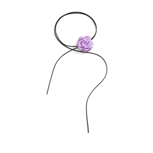 Close-up of a 3D purple satin rose choker with long black adjustable velvet cord ties