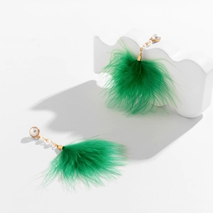 Detailed close-up of vintage green feather earrings with elegant white pearls and gold chains