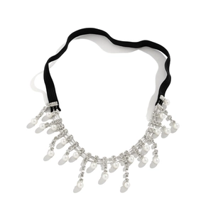 Detail of sexy thigh chain with elastic black band, sparkling rhinestones and white pearls