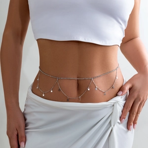 Detail of silver double-layered belly chain with rhinestones and star pendants on model