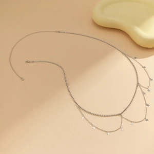 Detail view of silver double-layer waist chain with sparkling rhinestones and star charms