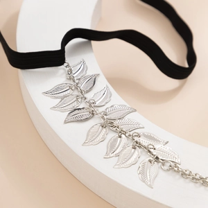 Close-up of silver leaf pendants with detailed veins on an elastic black band