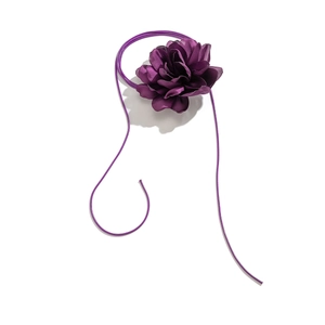 Detailed view of handmade purple fabric flower choker with long adjustable satin ribbons