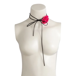 Close-up of a handmade rose flower choker necklace with pink satin petals and black cord