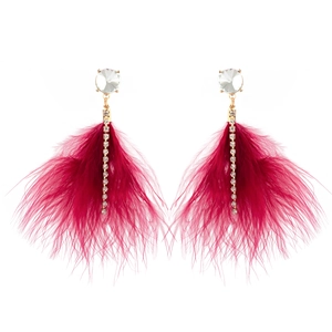 Detail of bohemian gold earrings with magenta feathers, rhinestones, and elegant tassels