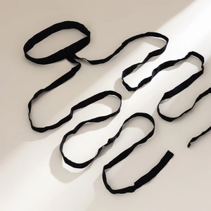 Detailed view of the sleek black velvet strap and elastic lace of the ring bracelet
