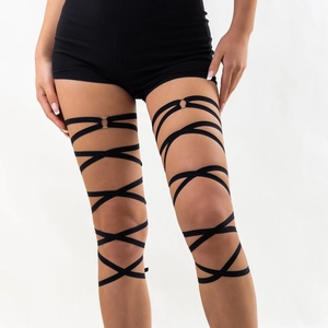 Detail of black multi-layer elastic leg garter with silver metal ring and punk strap design