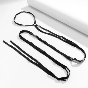 Detail of sexy black elastic leg chain with silver metal rings and cross straps on white