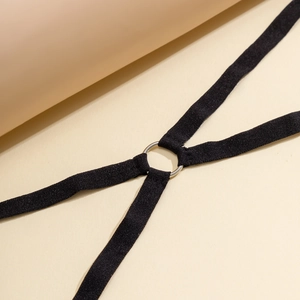 Detail of the black elastic leg chain featuring a silver metal ring and cross straps