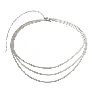 Detailed view of silver triple-layered snake chain with lobster clasp and extension