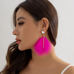 Detail of rose red feather earrings with rhinestone tassel on a female model