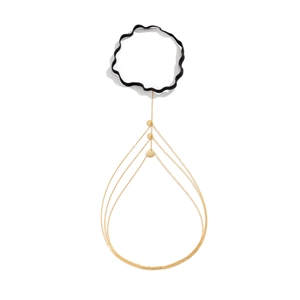 Detailed view of layered gold thigh chain with black elastic band and hammered discs
