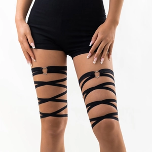 Detail of black elastic multi-layer leg chain with a silver heart-shaped metal buckle