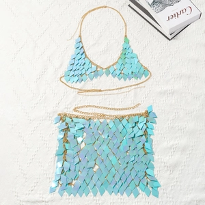 Detail of blue iridescent sequin bikini top and mini skirt with gold chain links