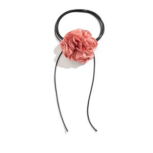 Detail of coral pink fabric flower choker with soft textile petals and adjustable cord
