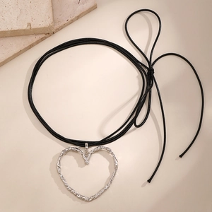 Dettaglio di un grande ciondolo a cuore argento con finitura lava su collana in cordino nero