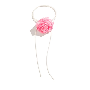 Close-up of pink layered satin flower choker with delicate petals and long white ties