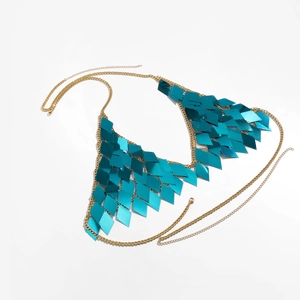 Close-up of turquoise diamond sequins on a gold metallic halter body chain bikini