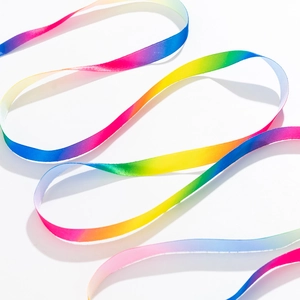 Detail view of colorful rainbow gradient satin ribbon with smooth silk reflective texture