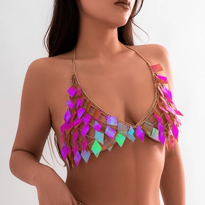 Detailed macro view of holographic diamond sequins and golden metal body chain textures