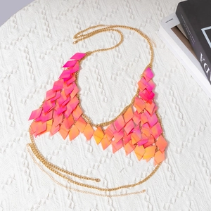 Detail of pink gradient sequins and golden chain on a chic bikini body accessory