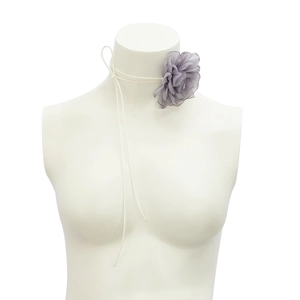 Close-up of a purple organza flower choker with adjustable white wax cord on a mannequin