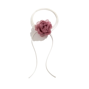 Detailed view of the layered dark pink fabric flower on a dual white headband