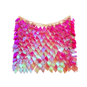 Close-up of sparkling magenta diamond sequins on a metallic grid body chain skirt