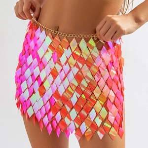 Macro detail of iridescent pink sequin body chain with adjustable gold metal link strap