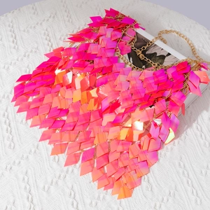 Detail of pink iridescent sequin mesh top with golden chains for beach body jewelry