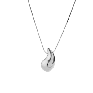 Macro detail of polished teardrop pendant on a silver snake chain necklace