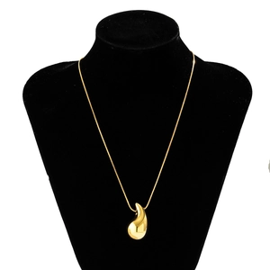 Polished gold teardrop pendant necklace on a sleek snake chain displayed on a black bust