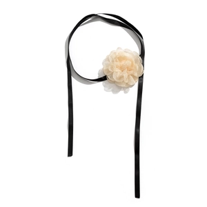 Detailed view of the layered beige silk flower on a black satin choker ribbon