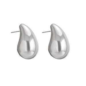 Macro detail of high-polish silver drop earrings with a minimalist mirror finish