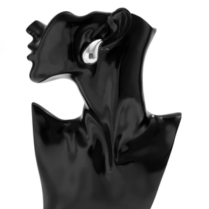 Close-up of a large polished silver teardrop earring on a black mannequin bust
