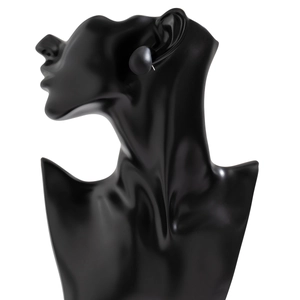 Close-up of minimalist black button stud earring on a sleek black fashion mannequin