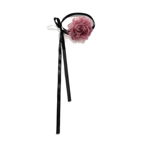Detail of a handmade pink chiffon flower choker with long black satin ribbons for styling