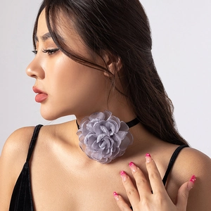 Detail of lavender organza flower choker with elegant velvet ties on a model's neck