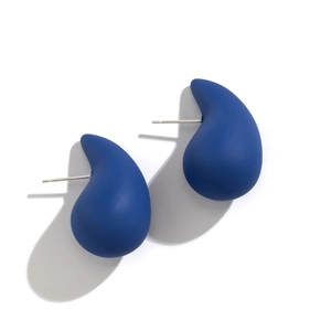 Macro detail of large matte royal blue teardrop earrings with silver metal pins