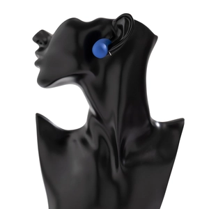 Close-up of matte blue geometric earring on a glossy black display mannequin head