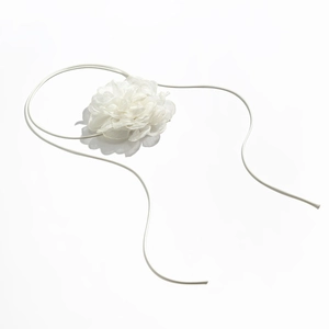 Detail of elegant white organza flower choker with adjustable long thin fabric ribbons